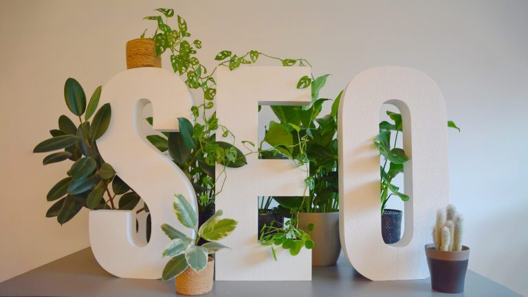 How Long Does Seo Take? A Realistic Timeline For Small Businesses 2 a white sign with plants and a potted plant next to it