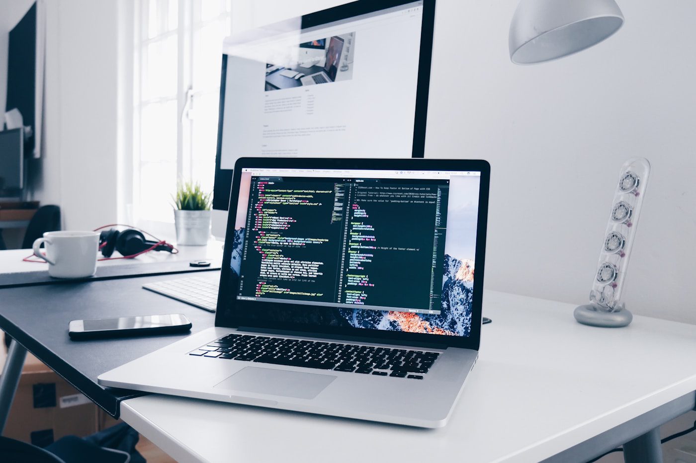 Designer working at laptop in warm workspace